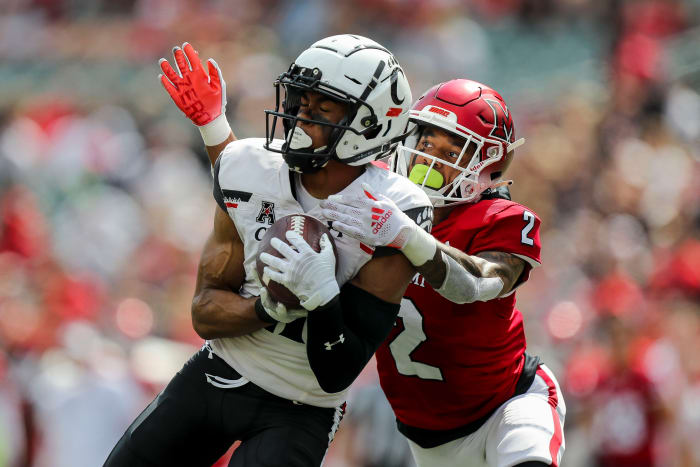 Sep 17, 2022; Cincinnati, Ohio, USA; Cincinnati Bearcats wide receiver Tyler Scott (21) catches a pass against Miami Redhawks defensive back Yahsyn McKee (2) in the second half at Paycor Stadium. Mandatory Credit: Katie Stratman-USA TODAY Sports
